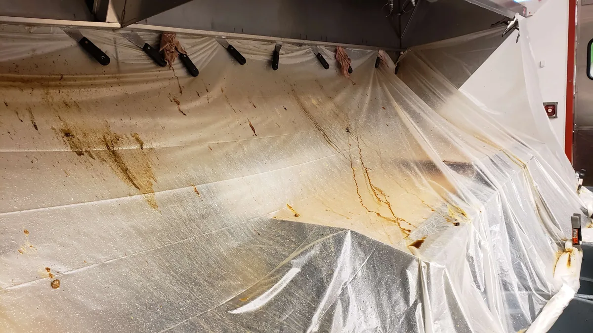 Close-up of commercial kitchen exhaust equipment and cleaning preparation